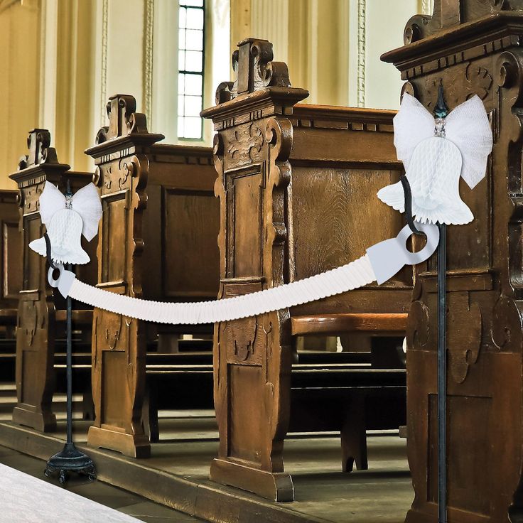 white ribbon tied to pews in an old church