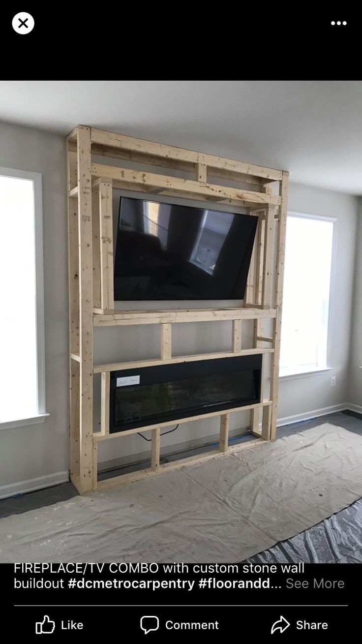 a tv mounted to the side of a wall in a living room with no furniture