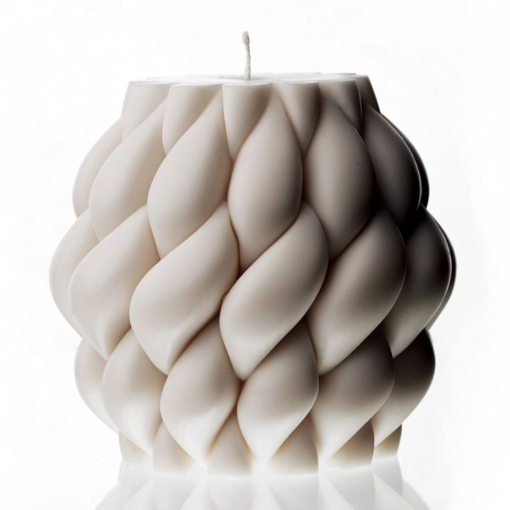 a candle that is sitting in the middle of some kind of sculpture on a table