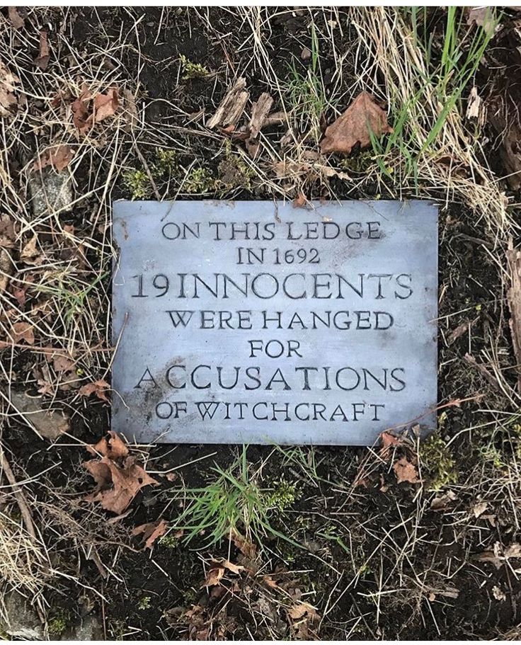 a plaque in the grass that says, on this ledge is 19 innocents were hanged for accusations of witchcraft