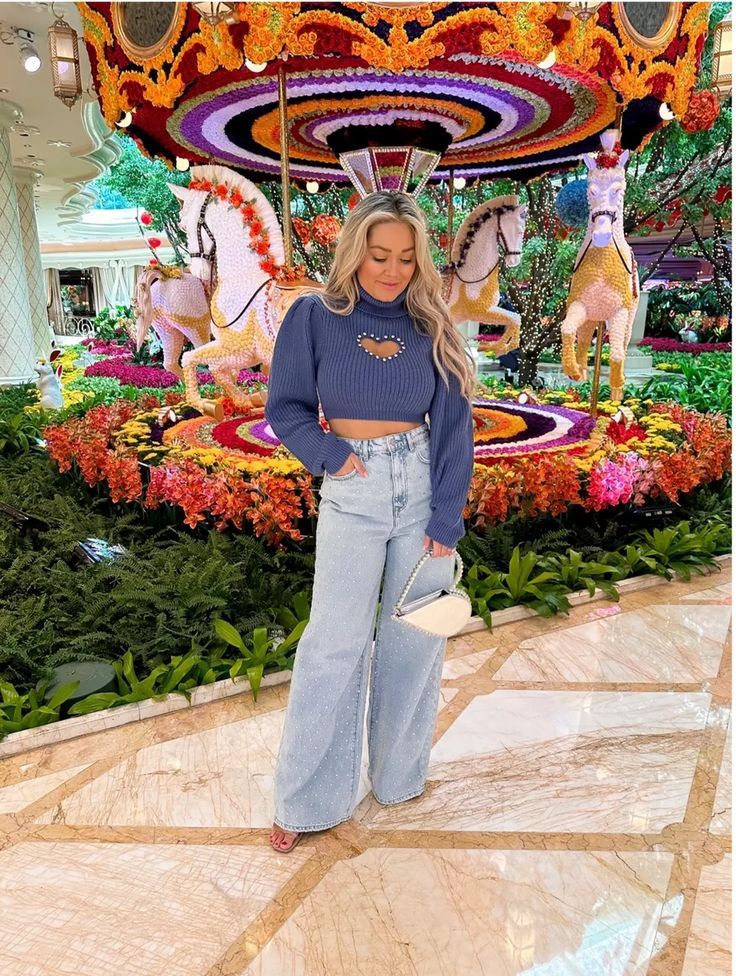 a woman standing in front of a carousel