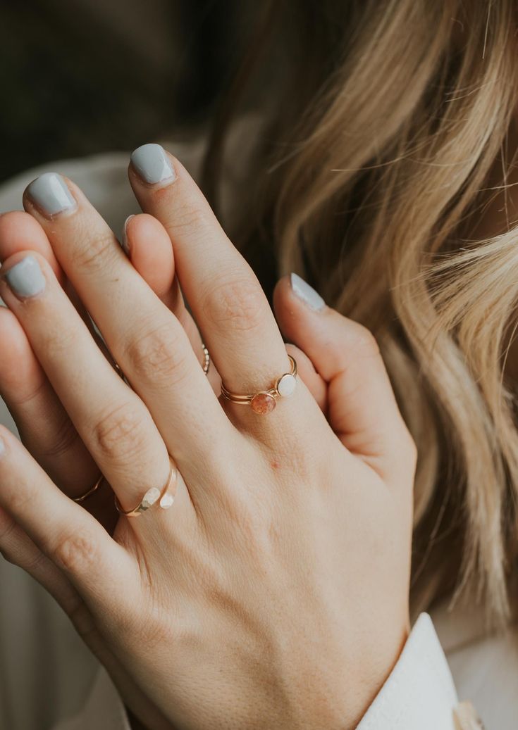 Our Sunny ring is made with a beautiful Sunstone gem. Known as a stone of joy, sunstone is believed to inspire good nature and an enjoyment of life. It’s a crystal connected to the sacral chakra which welcomes confidence and boosts creativity. 8x10mm oval or 6mm round sunstone. Ring band measures 1mm wide. Available in 14kt Gold Fill + Sterling Silver. Kayla stacks oval Sunny with our Confetti Ring and Revolve Ring. She styles round Sunny with our Sonder Ring and Poppy Ring. Handmade in Eau Clai Minimalist Rings With Raw Stone For Gift, Minimalist Gemstone Rings For Healing, Minimalist Healing Gemstone Rings, Minimalist Teardrop Stackable Jewelry, Dainty Oval Moonstone Promise Ring, Adjustable Raw Stone Promise Ring, Adjustable Oval Opal Ring Minimalist Style, Minimalist Oval Opal Ring For Gift, Minimalist Adjustable Oval Opal Ring