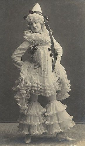 an old photo of a woman dressed in costume