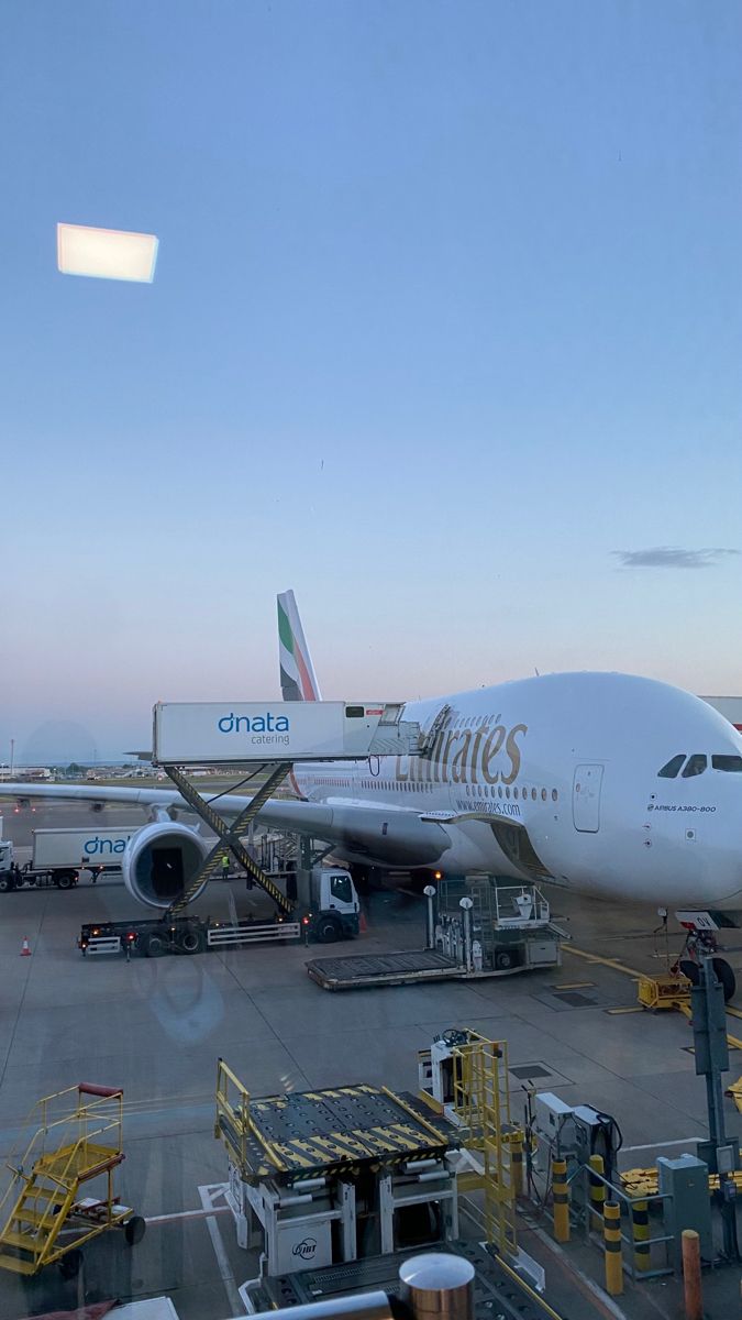 an airplane sitting on the tarmac at an airport