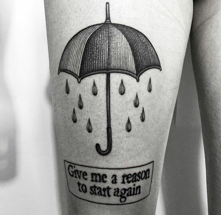 a woman's leg with an umbrella tattoo on it that says give me a reason to start again