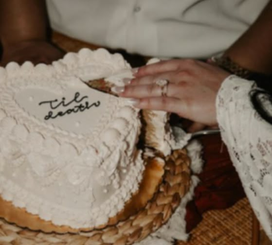 a close up of a person cutting a cake