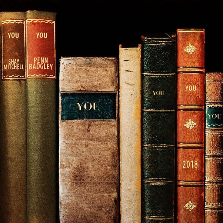 old books are lined up on a shelf