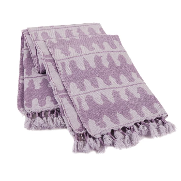 two purple and white towels on top of each other, one with an animal print