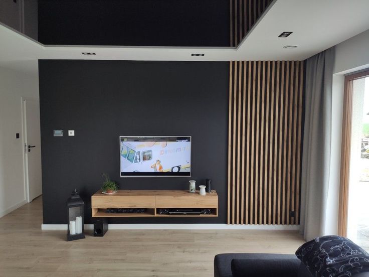 a flat screen tv sitting on top of a wooden entertainment center in a living room