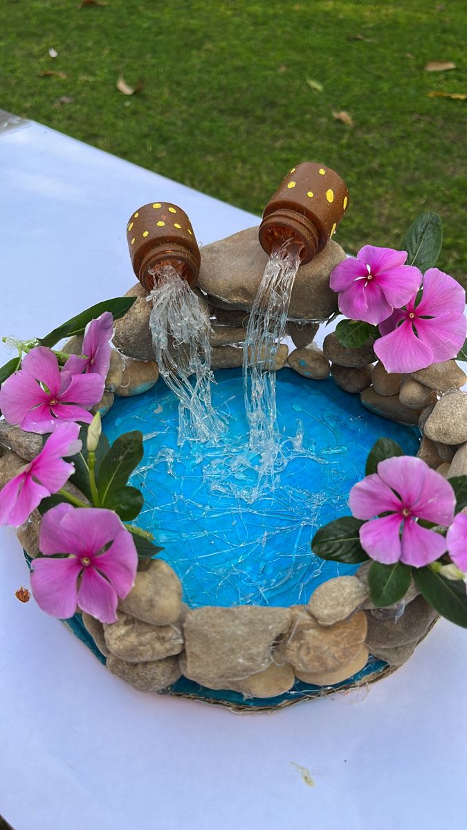 a cake decorated with flowers and water is on a table