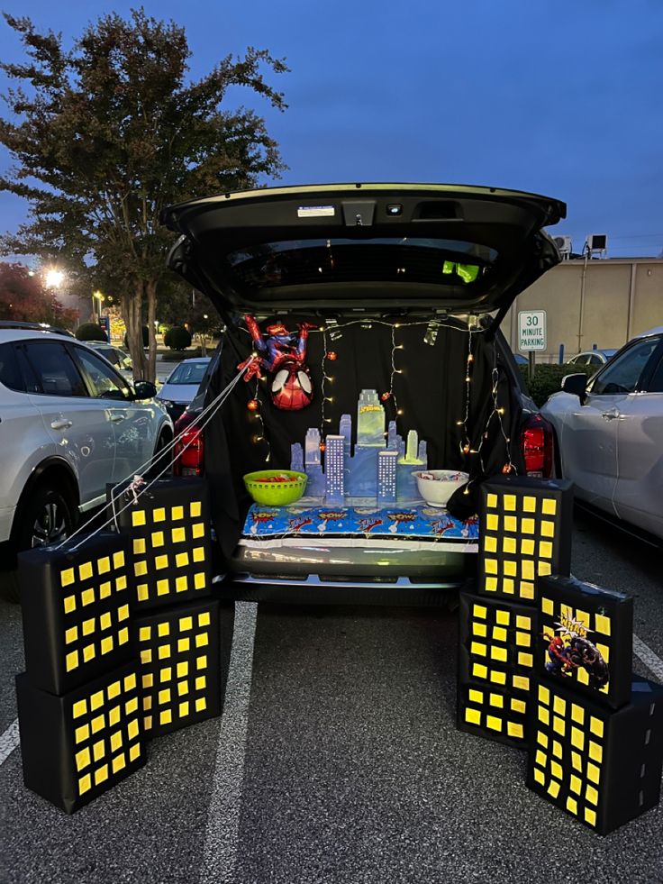 the back end of a car with its trunk open and decorations in it's trunk