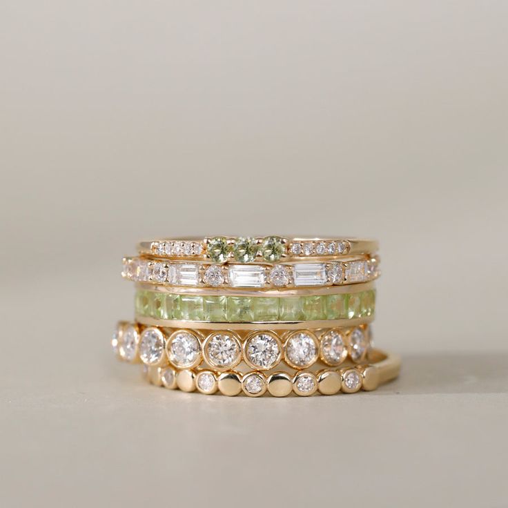 Adorn your finger with our Peridot Full Eternity Ring, a radiant celebration of August's birthstone. This exquisite piece showcases the warm allure of the green gemstone in a princess cut, offering a perfect blend of sophistication and individuality. Elevate your style with this timeless and vibrant symbol of elegance. Full Eternity Ring, Jewelry Lookbook, August Birth Stone, Green Gemstones, Jewelry Inspo, Dream Jewelry, Chic Boutique, Pretty Jewellery, Minimalist Jewelry