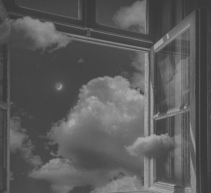 an open window with the sky and clouds reflected in it