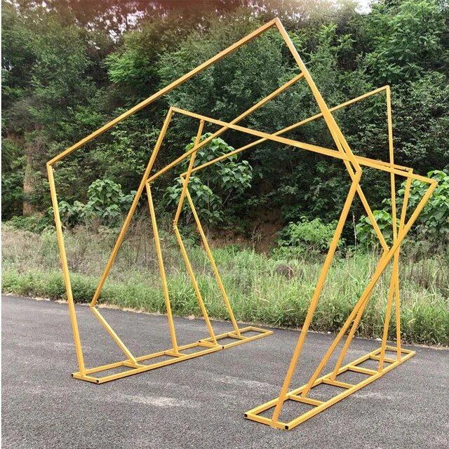 two yellow metal structures sitting on the side of a road