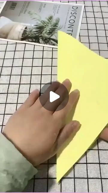 someone is cutting out a piece of paper with scissors