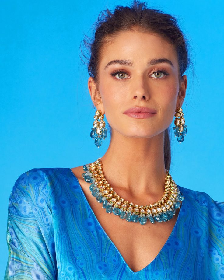 Drawing on jewelry from Mughal courts, the Sharawar Necklace in Sapphire Blue is an opulent showstopper. It adds a striking accent to many a NicoBlu style. May be worn as a reversible style, as the necklace is finished on both sides (one that is clear glass, the other repoussé enamel). • Gold plated • Sapphire blue glass • Reversible: clear glass on one side, repoussé enamel on the other • Slide tie closure, as shown • Hand-crafted • 6.5oz • Zinc free • Includes a NicoBlu gift bag (prints and co Romantic Dresses, Long Tunic Dress, New Canaan, Blue Gift, Romantic Dress, Blue Quartz, Long Tunic, Blue Necklace, Blue Paisley