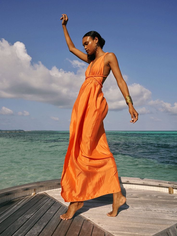 SUSTAINABLE CONVERTIBLE DRESS Artisanal and size-inclusive, the Mailys Dress is easily convertible into over 19 different styles. This garment is a comfortable and versatile dress thoughtfully designed to fit all body shapes and sizes. An essential piece for every closet! Convertible design, wraps into over 19 differen Beach Formal Attire, Orange Dress Outfits, Beach Formal, Jungle Wedding, Resort Casual, Dakar Senegal, Guest Attire, Convertible Dress, Resort Dresses