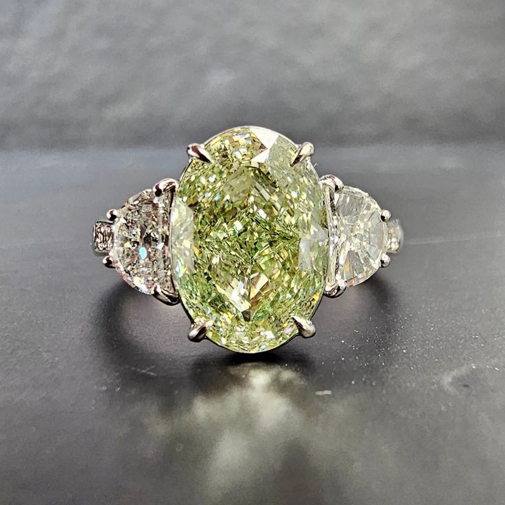 3.55 Carat GIA Fancy Light Brownish Greenish Yellow Oval Cut Diamond VVS2 Clarity 0.60 Carat Half Moons Handmade in 18k White Gold GIA Certified Luxury Green Marquise Diamond Ring, Green Oval Diamond Ring With Diamond Cut, Green Oval Diamond Ring With Vvs Clarity, Luxury Oval Diamond Ring, Luxury Oval Diamond Cut Rings, Luxury Yellow Oval Rings, Gia Certified Oval Diamond Ring, Gia Certified Oval Diamond Ring Fine Jewelry, Luxury Pear-shaped Three Stone Rings