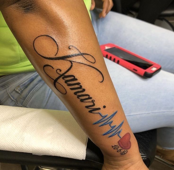 a woman with a tattoo on her arm that reads, mom and music notes in cursive writing