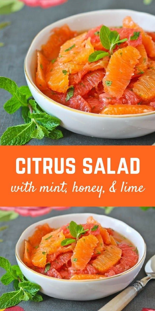 citrus salad with mint, honey and lime in a white bowl on top of a table