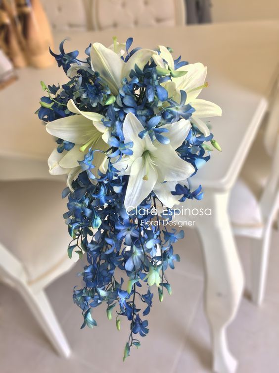 a blue and white bouquet sitting on top of a table next to a dining room table