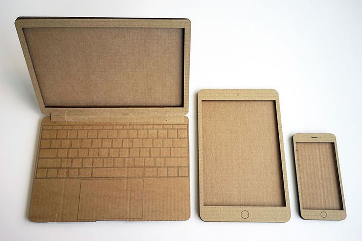 an open laptop computer sitting on top of a wooden box next to a cell phone