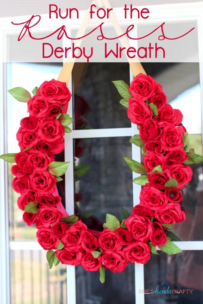 a wreath made out of red roses sitting in front of a window with the words, run for the rose derby wreath