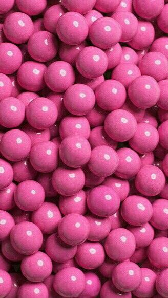 pink candy balls are piled on top of each other