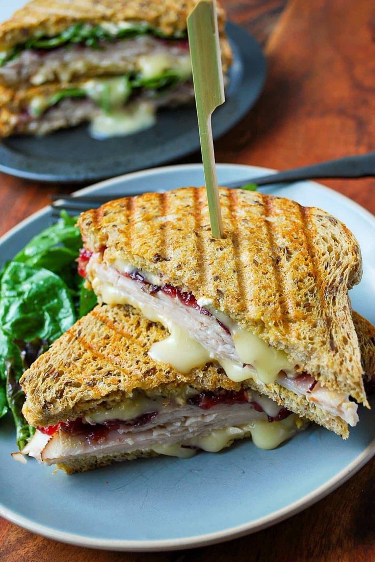 a cut in half sandwich sitting on top of a blue plate