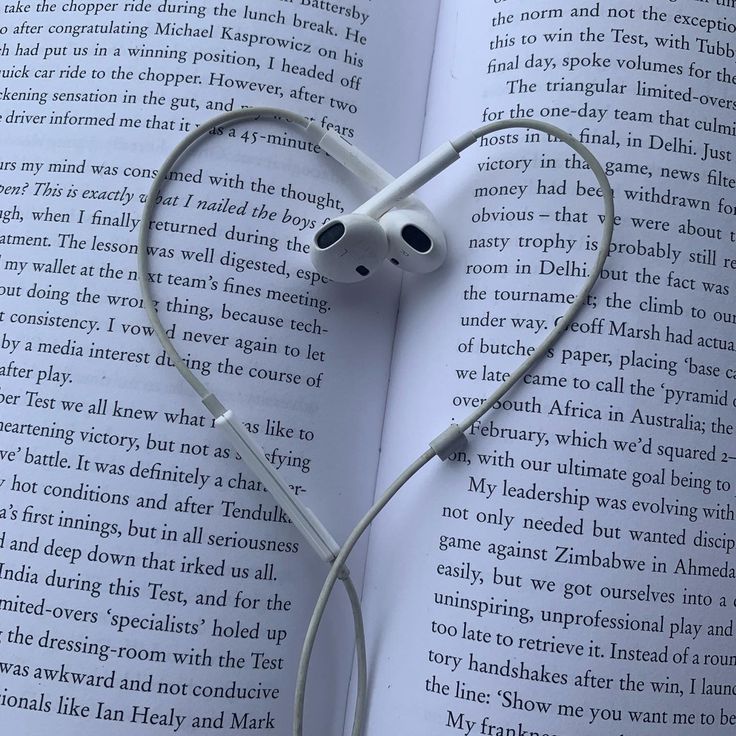 an open book with headphones attached to it