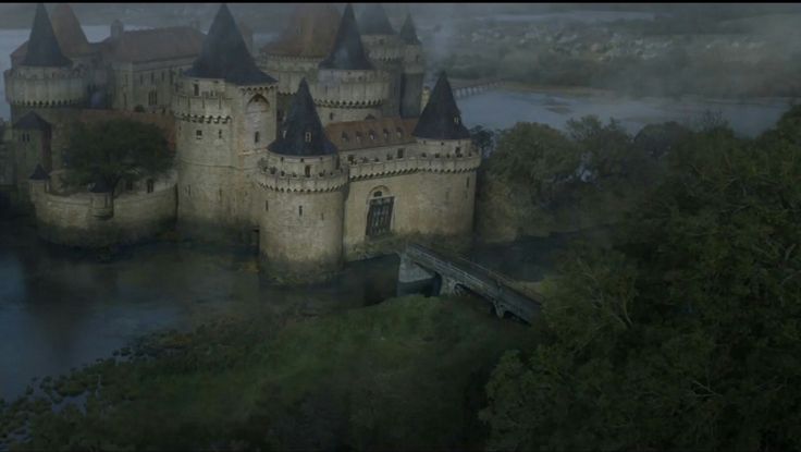 an aerial view of a castle in the fog