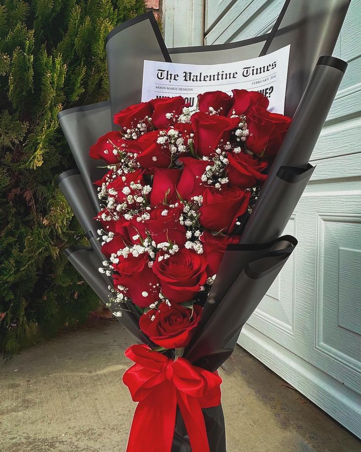 a large bouquet of red roses in front of a garage door