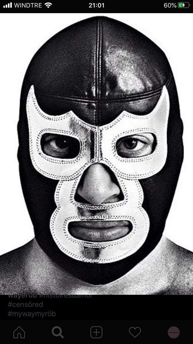 a black and white photo of a wrestler with his face painted like a wrestling mask