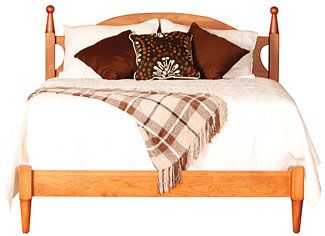 a bed with wooden headboard and foot board, pillows and blankets on the pillow