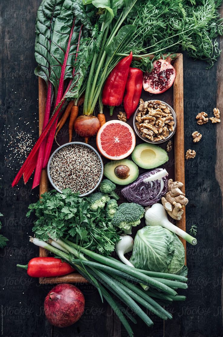 an assortment of fruits and vegetables laid out on a cutting board by jorgon for stocks