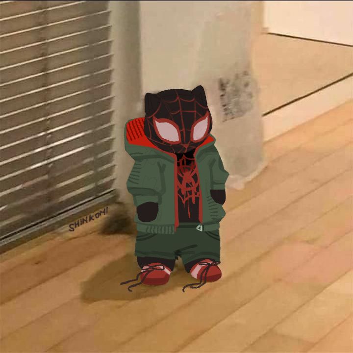 a little kid in a spider - man costume is standing on the floor