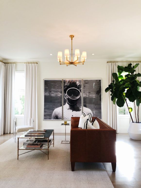 a living room filled with furniture and a painting on the wall