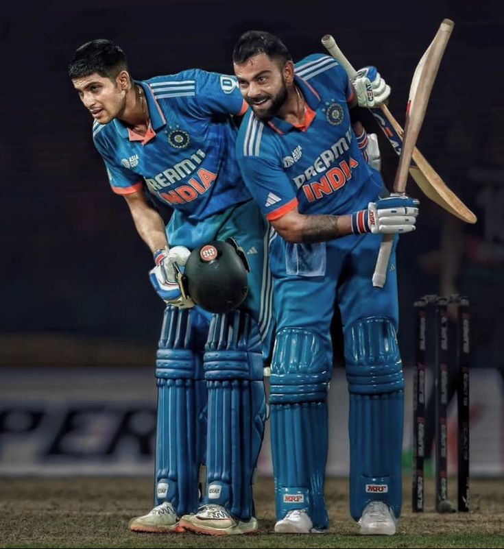 two men standing next to each other with their arms around one another and holding bats