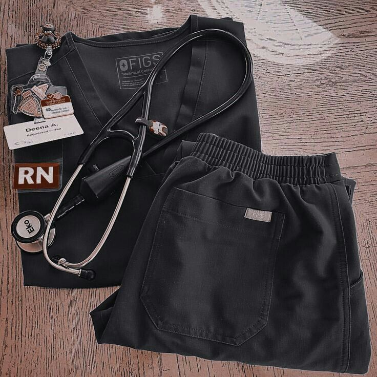 a doctor's uniform and stethoscope laying on a wooden floor next to it