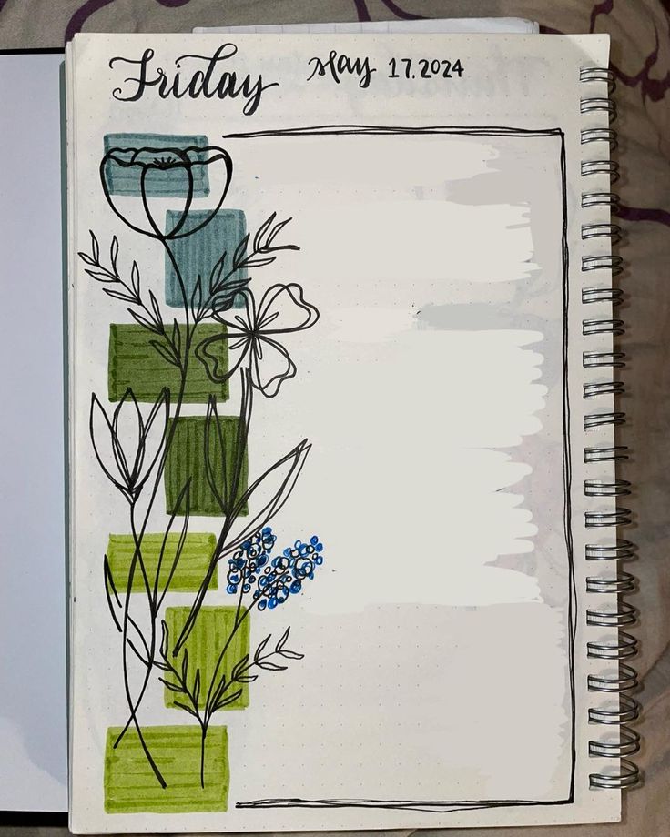 an open notebook with some flowers on it