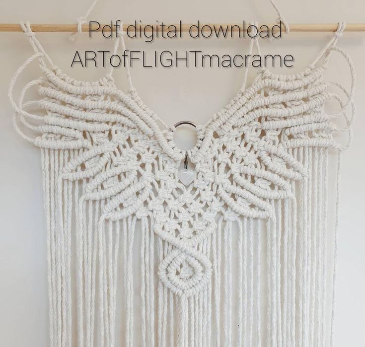 white macrame wall hanging with angel wings