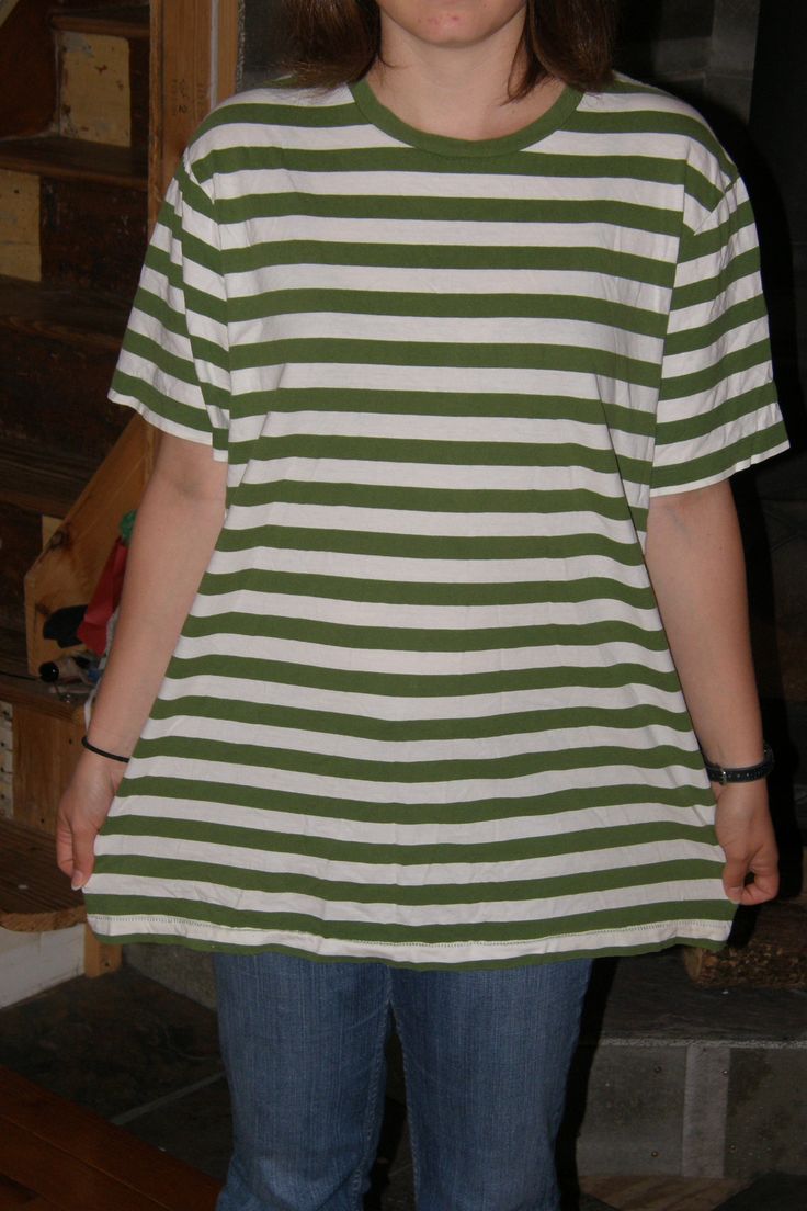 a woman wearing a green and white striped shirt