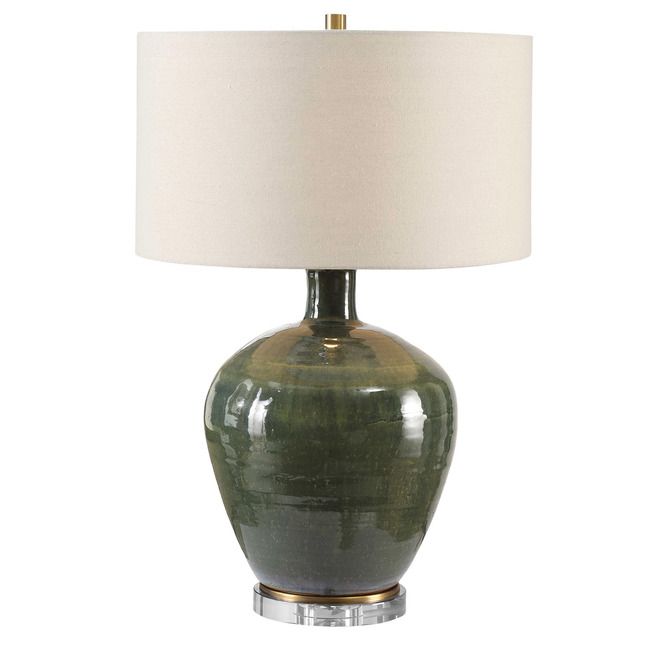 a green lamp with a white shade on it