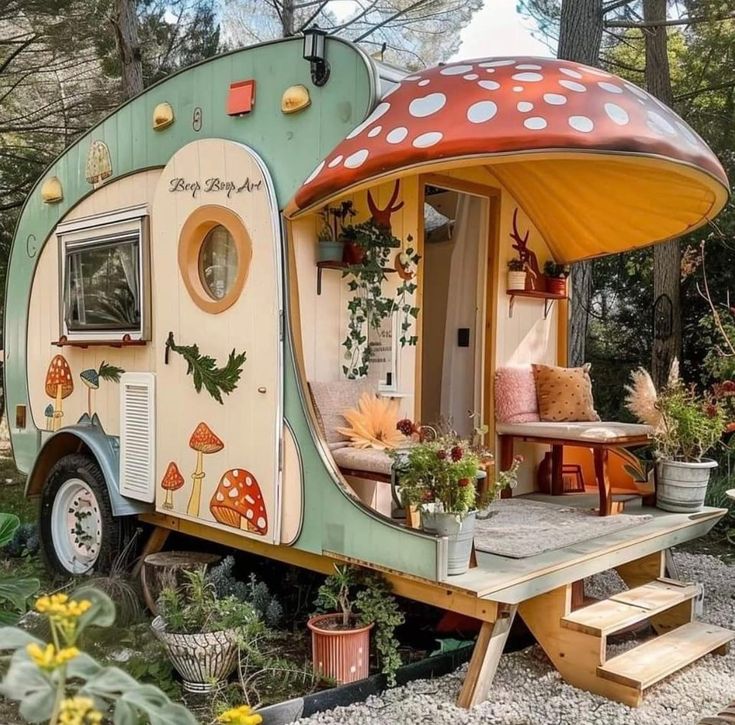 an old camper converted into a tiny house with mushrooms on the roof and windows