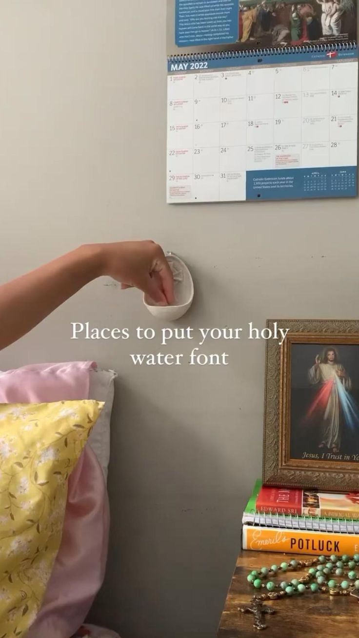 there is a clock on the wall next to a bed with books and other items