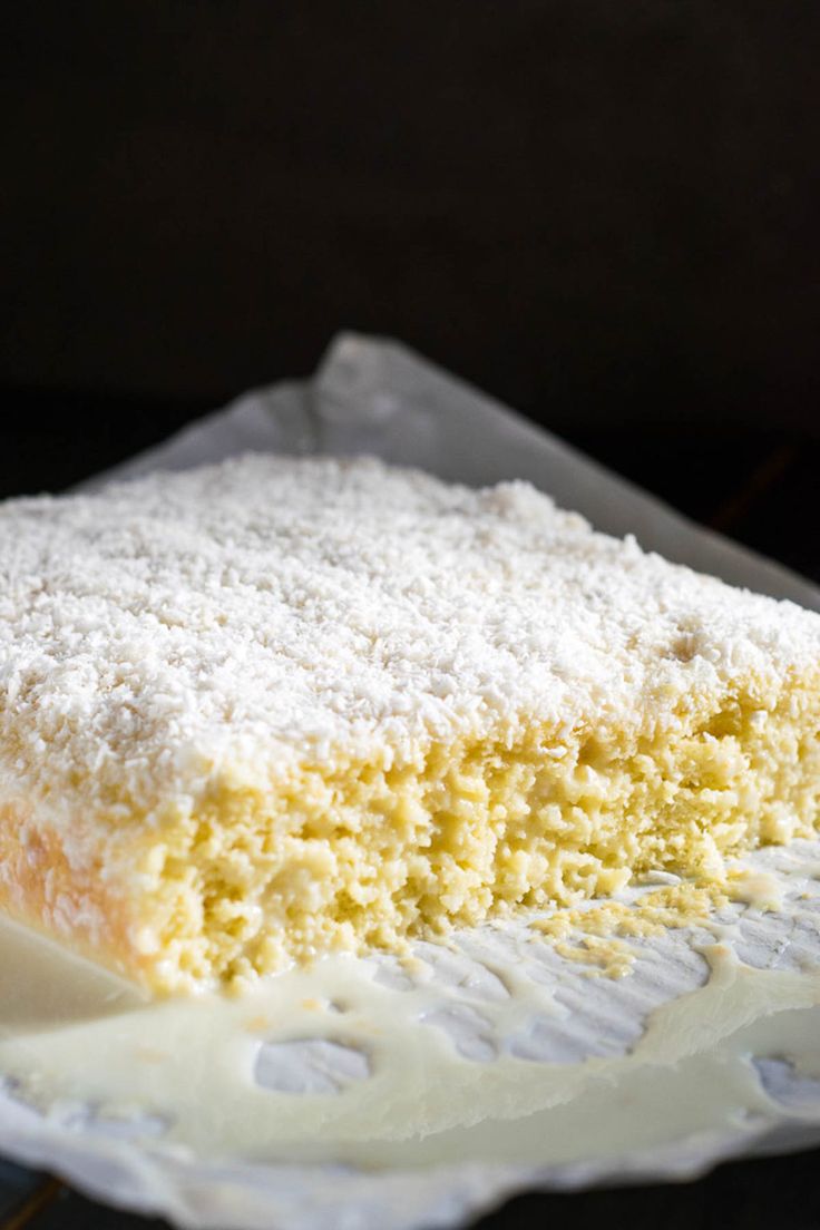 a close up of a piece of cake on a plate with the words bollo gelado de coco