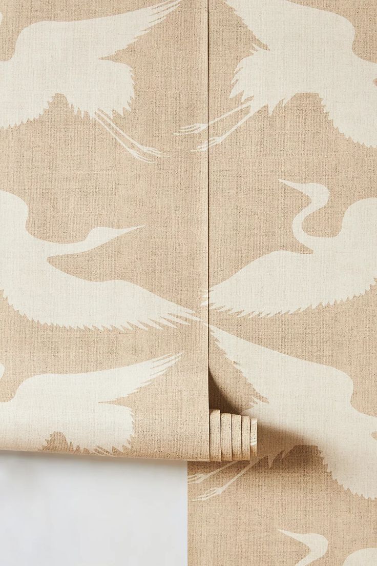 the back side of a curtain with birds on it and beige fabric behind it, in front of a white background