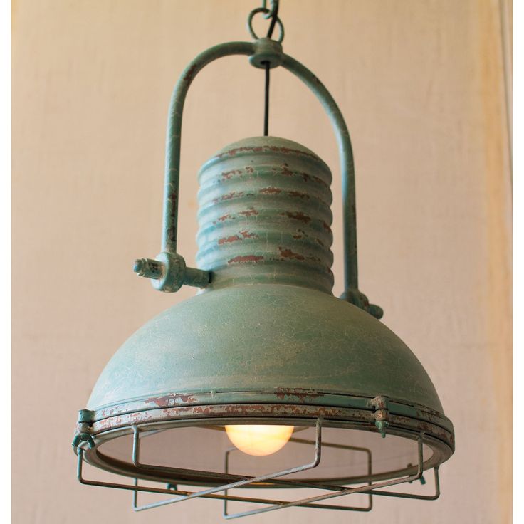 an old fashioned light hanging from a ceiling