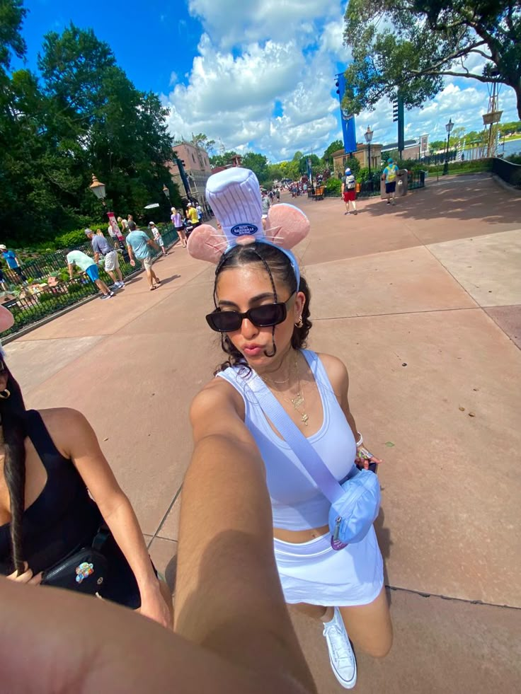 a woman is taking a selfie in front of the camera while wearing bunny ears