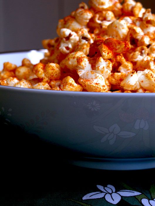 a bowl filled with popcorn sitting on top of a table